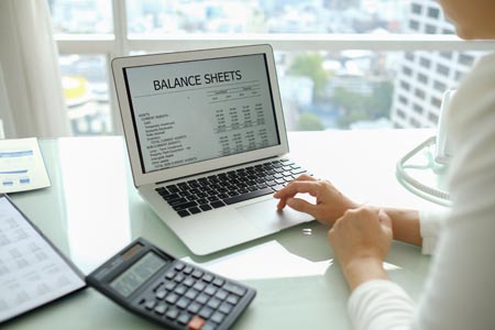 accounting report spreadsheet. accountant women using computer prepare financial report.